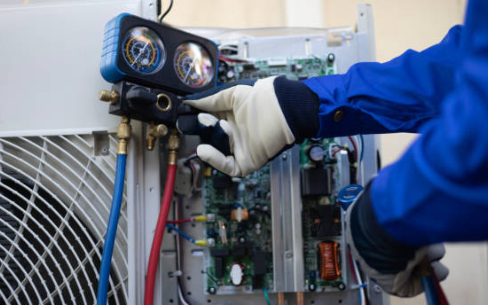 HVAC technician using gauges while diagnosing residential heating and cooling equipment