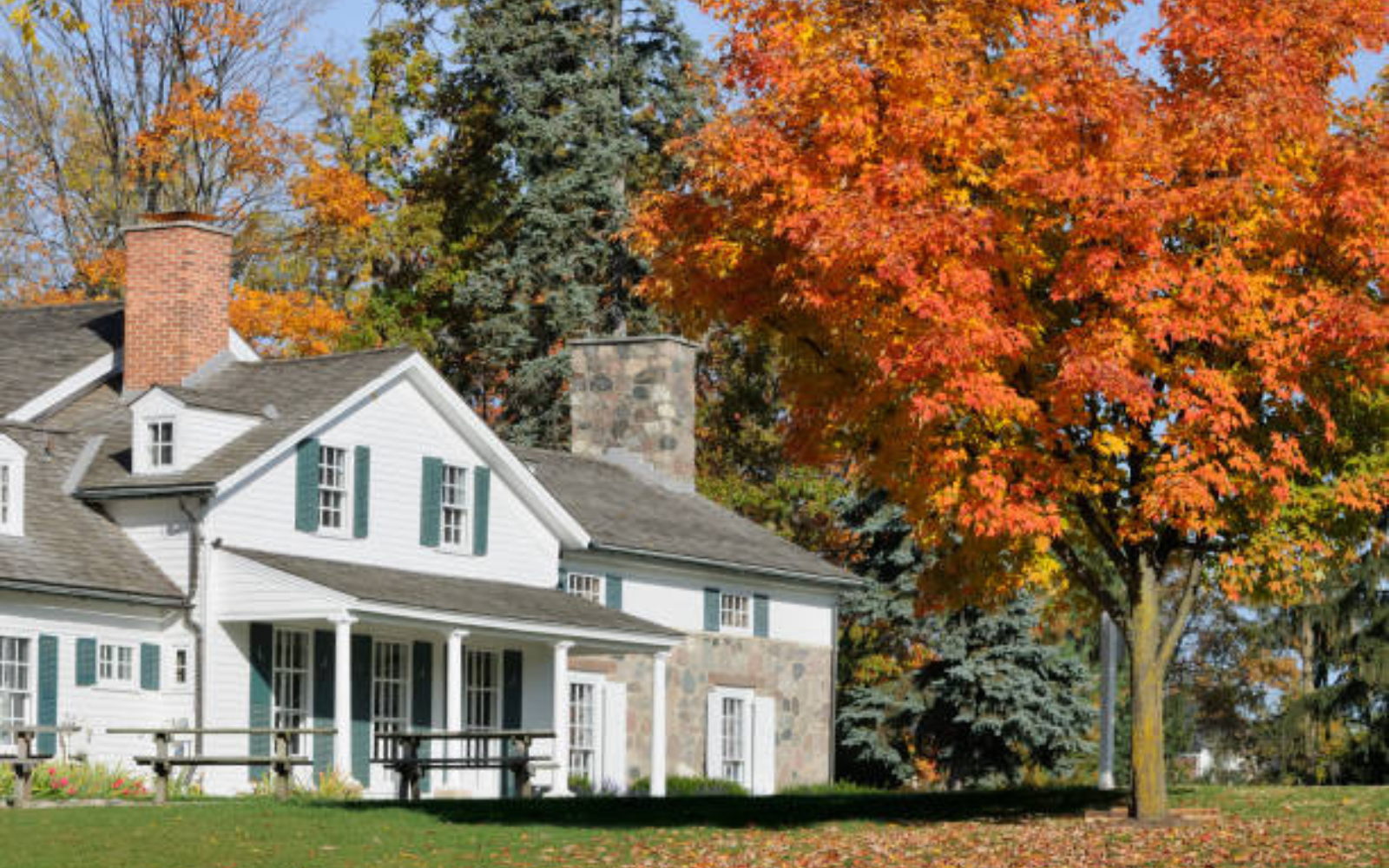 Suburban home surrounded by bright autumn foliage